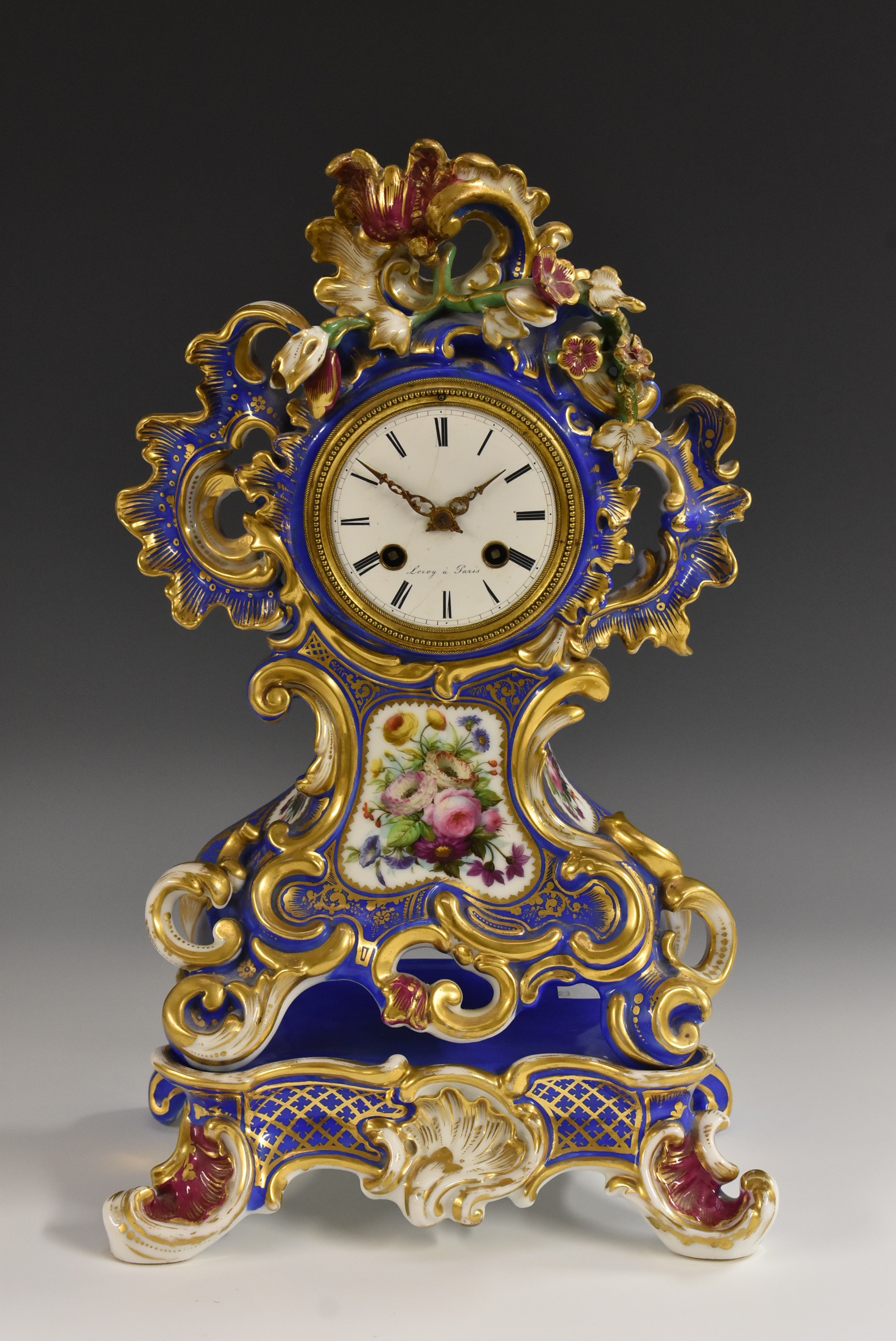 A 19th century French porcelain cartouche-shaped mantel clock,