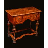 A 'William and Mary' walnut lowboy, quarter-veneered crossbanded top above three frieze drawers,