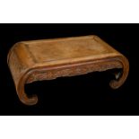 A Chinese hardwood low tea table, rectangular panel top above a deep frieze carved with trellis,