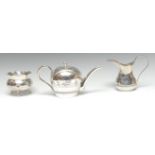 A Middle Eastern silver three piece tea service, comprising teapot, milk jug and sugar basin,