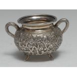 A Chinese silver two-handled cauldron shaped bowl, profusely chased with blossoming prunus, 9.