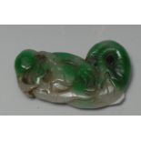 A Chinese two-tone jade amulet, of a Shou-Lao as a merman,