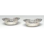 A pair of George V silver shaped oval sweetmeat baskets, pierced borders, 16cm wide,