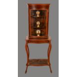 An Edwardian satinwood crossbanded mahogany serpentine display cabinet,