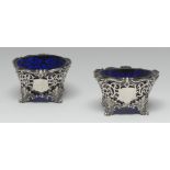 A pair of William IV Rococo Revival silver shaped circular salts, pierced borders, acanthus feet,