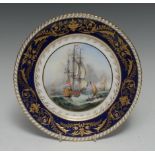 A Lynton shaped circular plate, painted by Stefan Nowacki, with galleons and sailing boats,