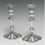 A pair of George II cast silver table candlesticks, of substantial gauge, fluted detachable nozzles,