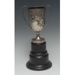A Chinese silver presentation cup, repousse chased with a ferocious dragon, scroll handles,