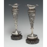 A pair of Chinese silver trumpet shaped mantel vases, pierced and embossed with blossoming prunus,