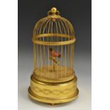 A Swiss gilt metal automaton, as a singing bird in a cage, 29.