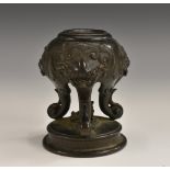 A Chinese dark-patinated bronze candlestick,