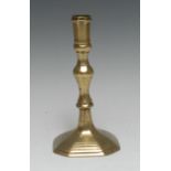 A late 17th century French brass candlestick, panelled sconce, knopped stem,