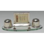 An Art Deco silver and clear glass oval desk stand,