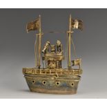 A silver coloured metal nef, as a battle ship, with masts, flags and canons,