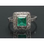 An emerald and diamond ring, central square table cut emerald approx 0.