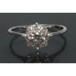 A diamond cluster ring, central round brilliant cut diamond, approx 0.