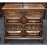 A Charles II oak block-front chest, rectangular moulded top above two short and three long drawers,
