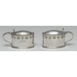 Guild of Handicraft - a pair of Arts and Crafts silver oval mustards, of George III design,