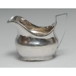 A George III silver boat shaped cream jug, wriggle-work engraved with Greek key,