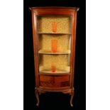 An Edwardian mahogany bow fronted display cabinet,