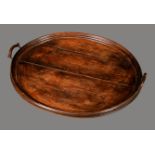 A 19th century oval butler's gallery tray, moulded border, arched carrying handles,
