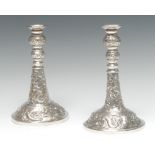 A near pair of Chinese silver candlesticks,