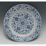 A Chinese circular charger, painted in tones of blue with flowers and scrolling leaves, 39cm diam,