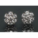 A pair of seven stone diamond floral cluster earrings,