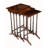 A nest of three Regency rosewood and simulated rosewood occasional tables,