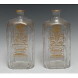 A pair of 19th century Dutch shaped rectangular decanters, decorated in gilt with stylised tulips,