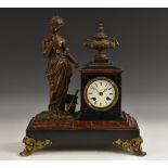 A 19th century French brown-patinated bronze and rouge marble and noir Belge mantel clock,