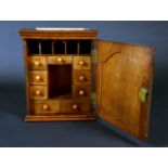 A George III oak spice cupboard,