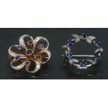 A diamond and sapphire floral ribbon brooch, seven individually mounted deep blue sapphires,