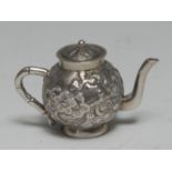 A Chinese silver miniature teapot, chased with blossoming prunus, faux bamboo handle, 4.