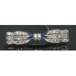 An Art Deco diamond and sapphire tied bow brooch,