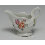 A Lowestoft shell moulded ewer, painted in colour with scattered flowers, 10cm wide, c.