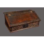 An 18th century oak boarded desk box, hinged sloping cover enclosing three small drawers,