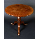 A George III mahogany tripod occasional table, circular tilting top,