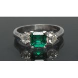 A Columbian emerald and diamond trilogy ring, central square cushion cut vibrant green emerald,