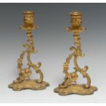 A pair of Victorian rococo gilt metal candlesticks, with detachable nozzles,