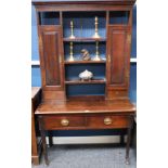 A 'George III' oak dresser, moulded outswept cornice above an open plate rack,