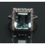 An aquamarine and diamond ring, central rectangular table cut aquamarine, measuring 11.03mm x 10.