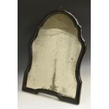 A Queen Anne ebonised shaped easel looking glass, mirror plate,