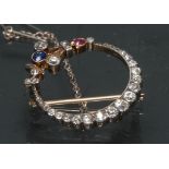 An Edwardian diamond sapphire and ruby floral crescent brooch,