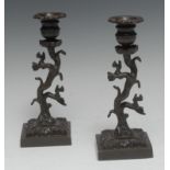 A pair of Regency brown patinated bronze candlesticks,