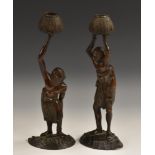 Japanese School (Meiji period), a pair of novelty brown-patinated bronze figural candlesticks,