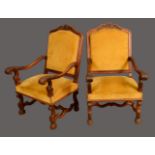 A pair of 18th century style walnut elbow chairs, shaped arched rectangular backs,