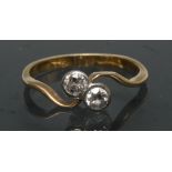 A diamond crossover twist ring, inset with two old brilliant cut diamonds, each approx 0.