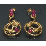 A pair of unusual insect drop earrings, each with two insects within scrolling stem frame mounts,