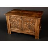 A 17th century oak two panel blanket chest, hinged top enclosing a till,